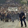 A protestor gestures to police near the Parliament building in the center of Athens.  A nationwide general strike gripped Greece in the first major test of the socialist government.